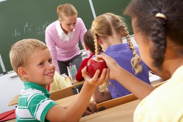 School kid sharing an apple