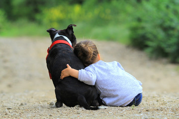 kid hugging dog
