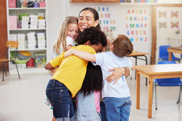 teacher hugging 3 kids